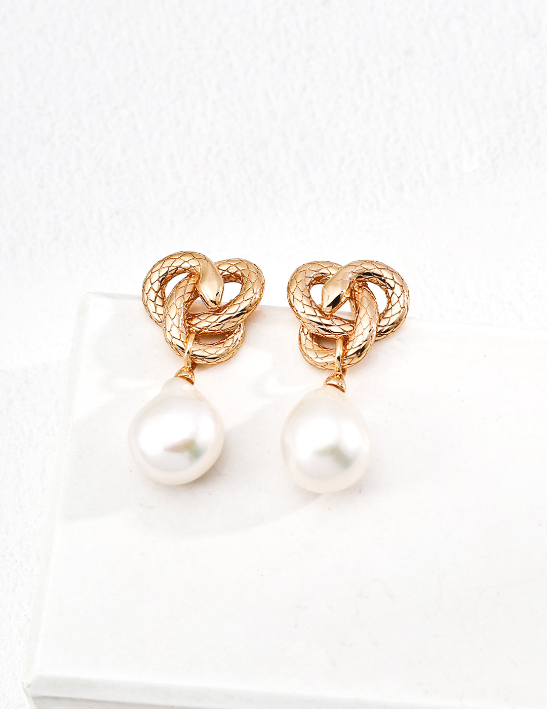 Golden Snake Coiling Around a Pearl