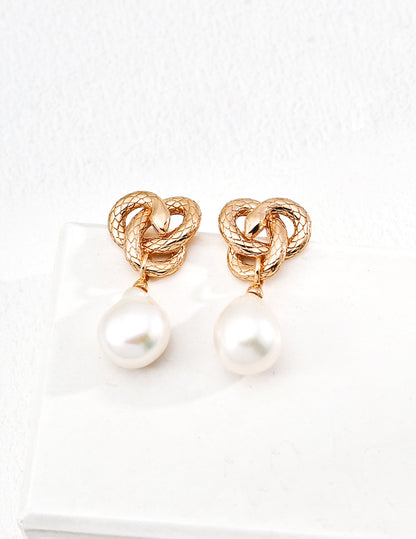 Golden Snake Coiling Around a Pearl